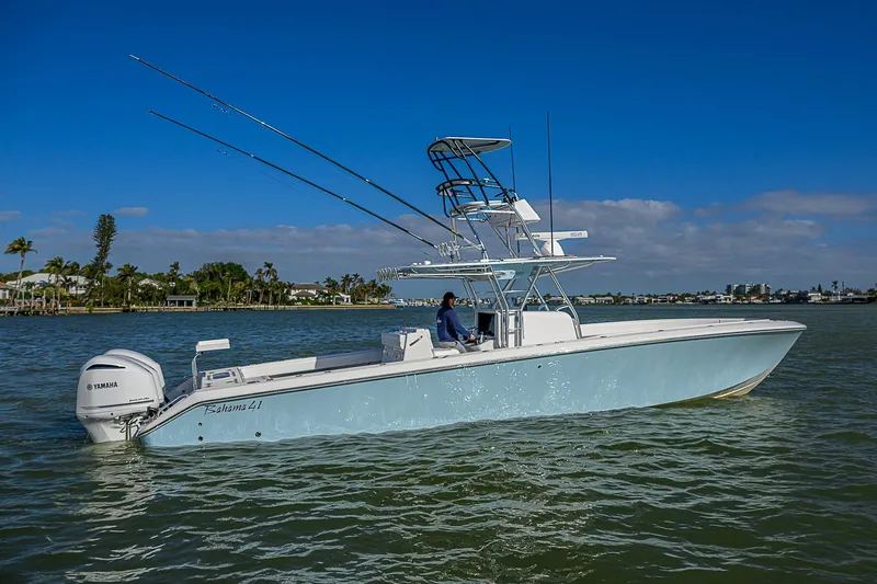 Grand Slam Yacht Photos Pics 2017 Bahama 41 boat on water, clear sky, palm trees in background.