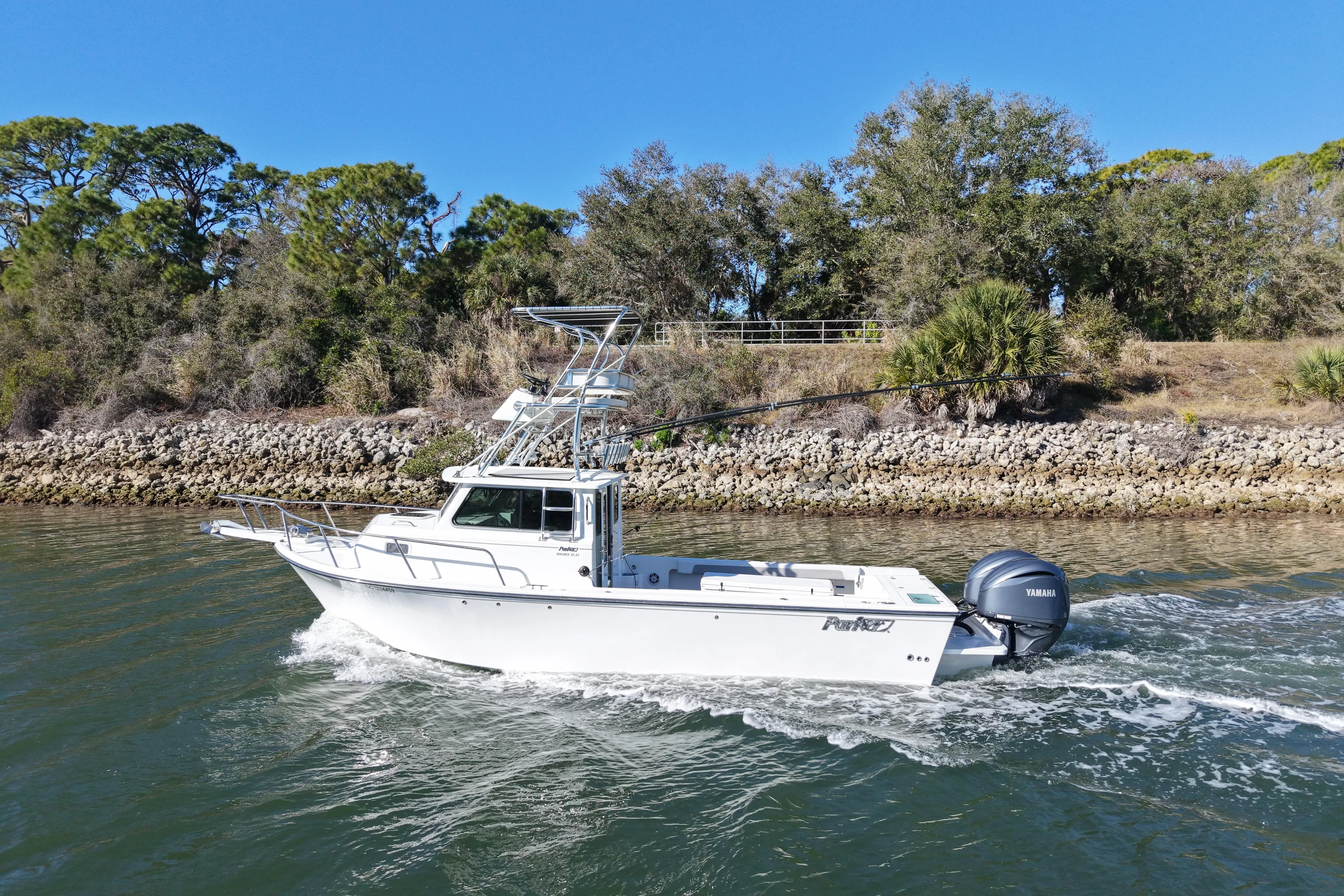 2023 Parker 2820 XLD Sport Cabin boat cruising on a scenic waterway.