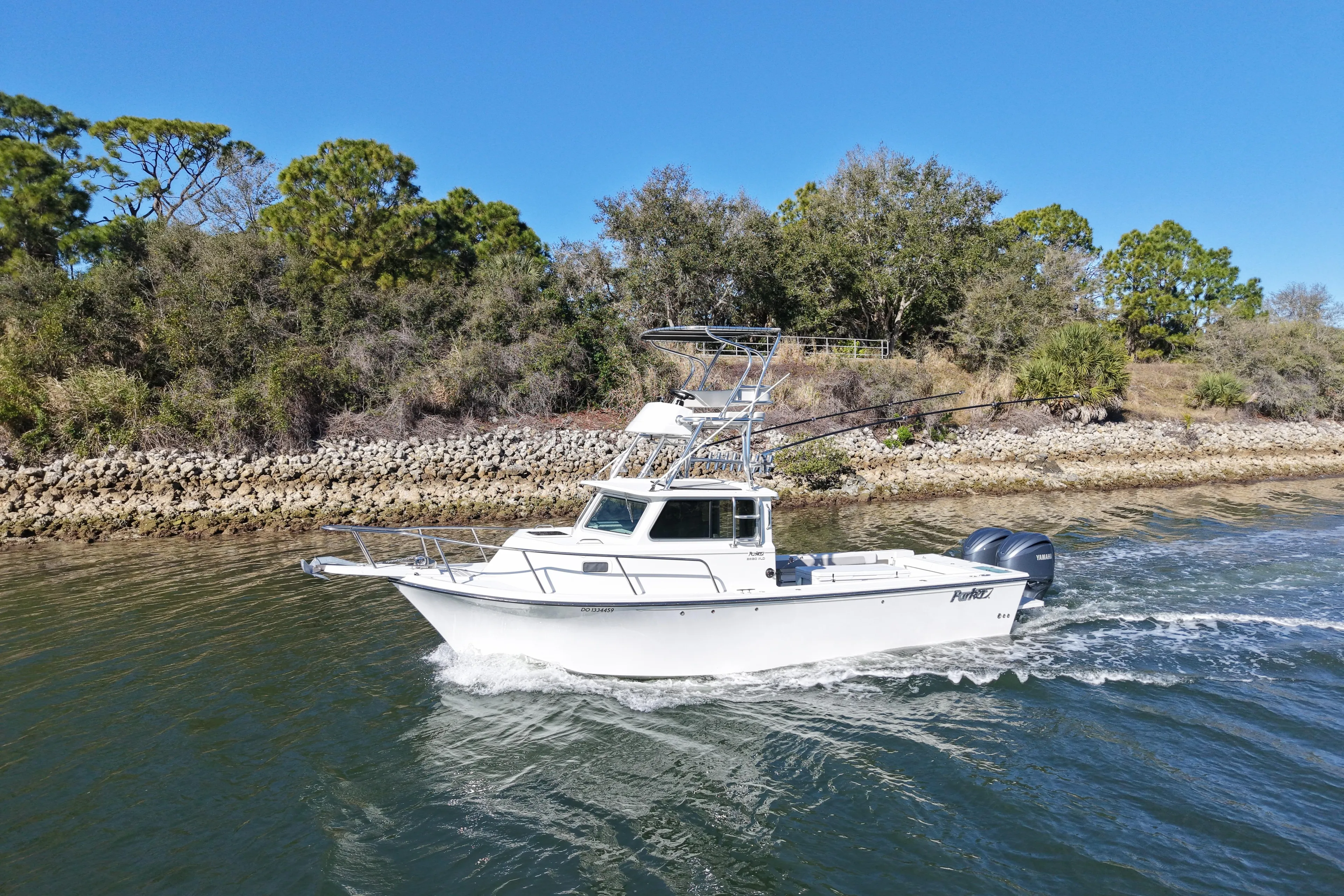 2023 Parker 2820 XLD Sport Cabin boat cruising on a scenic waterway.