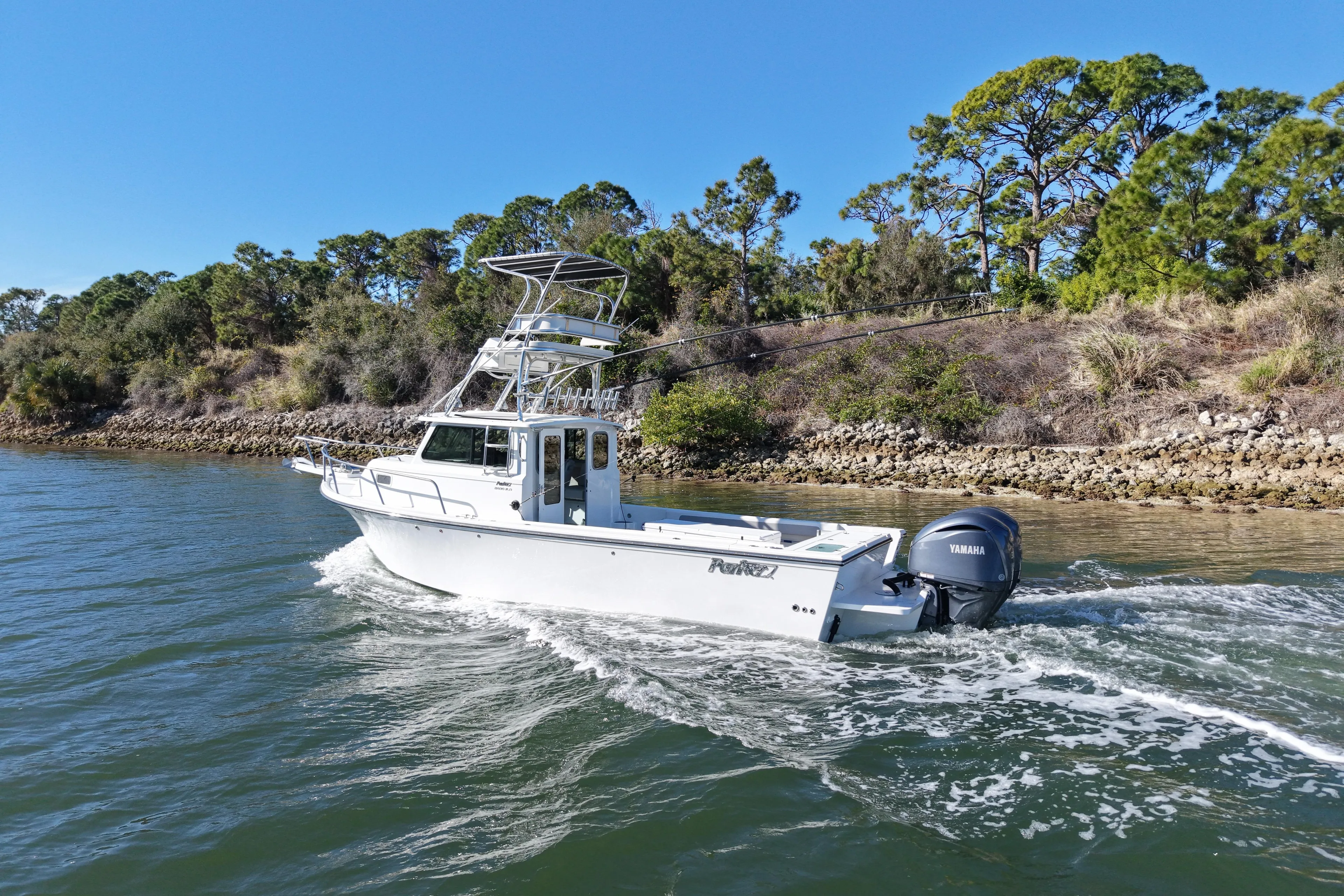 2023 Parker 2820 XLD Sport Cabin boat cruising on a scenic waterway.