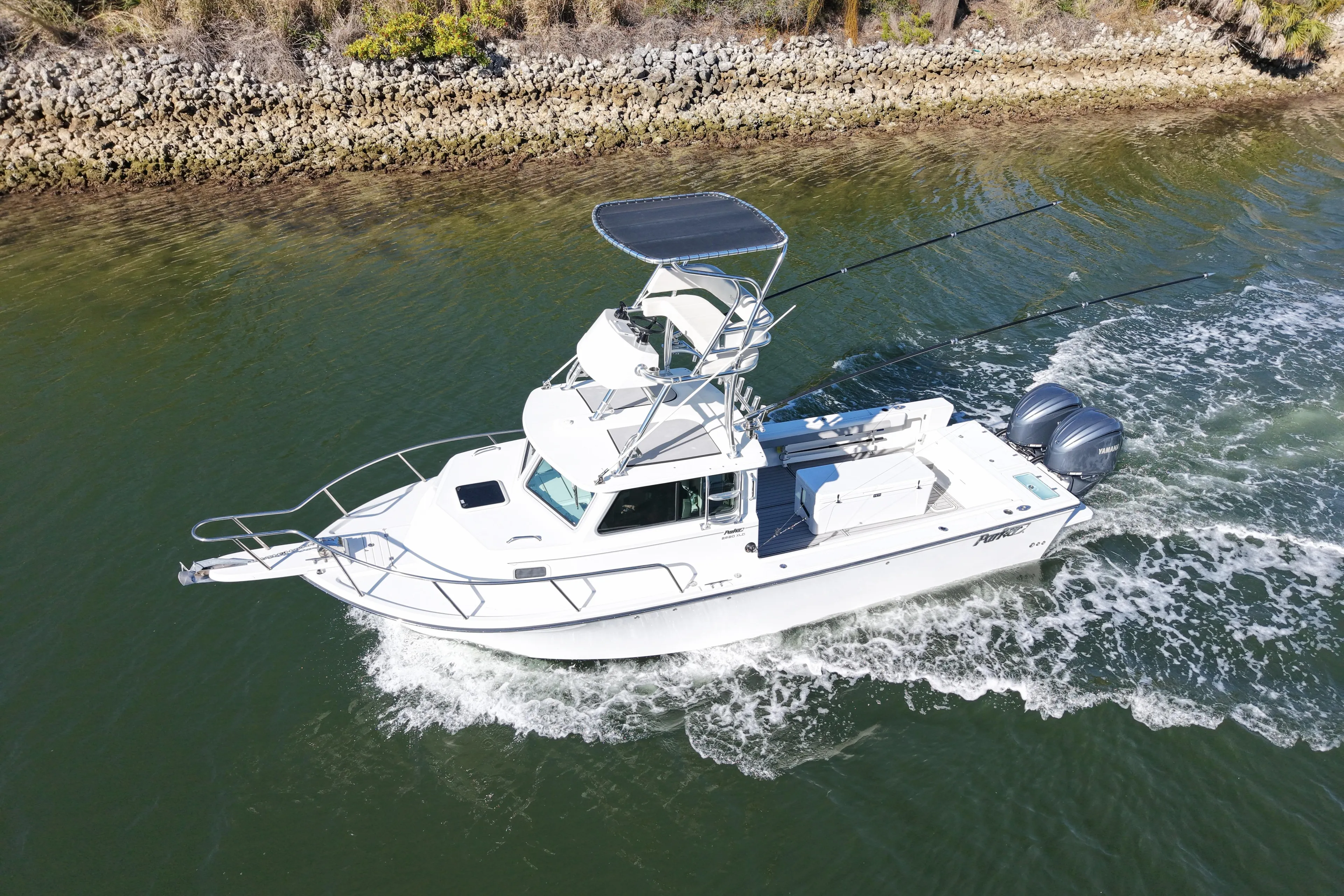 2023 Parker 2820 XLD Sport Cabin boat cruising on a river.