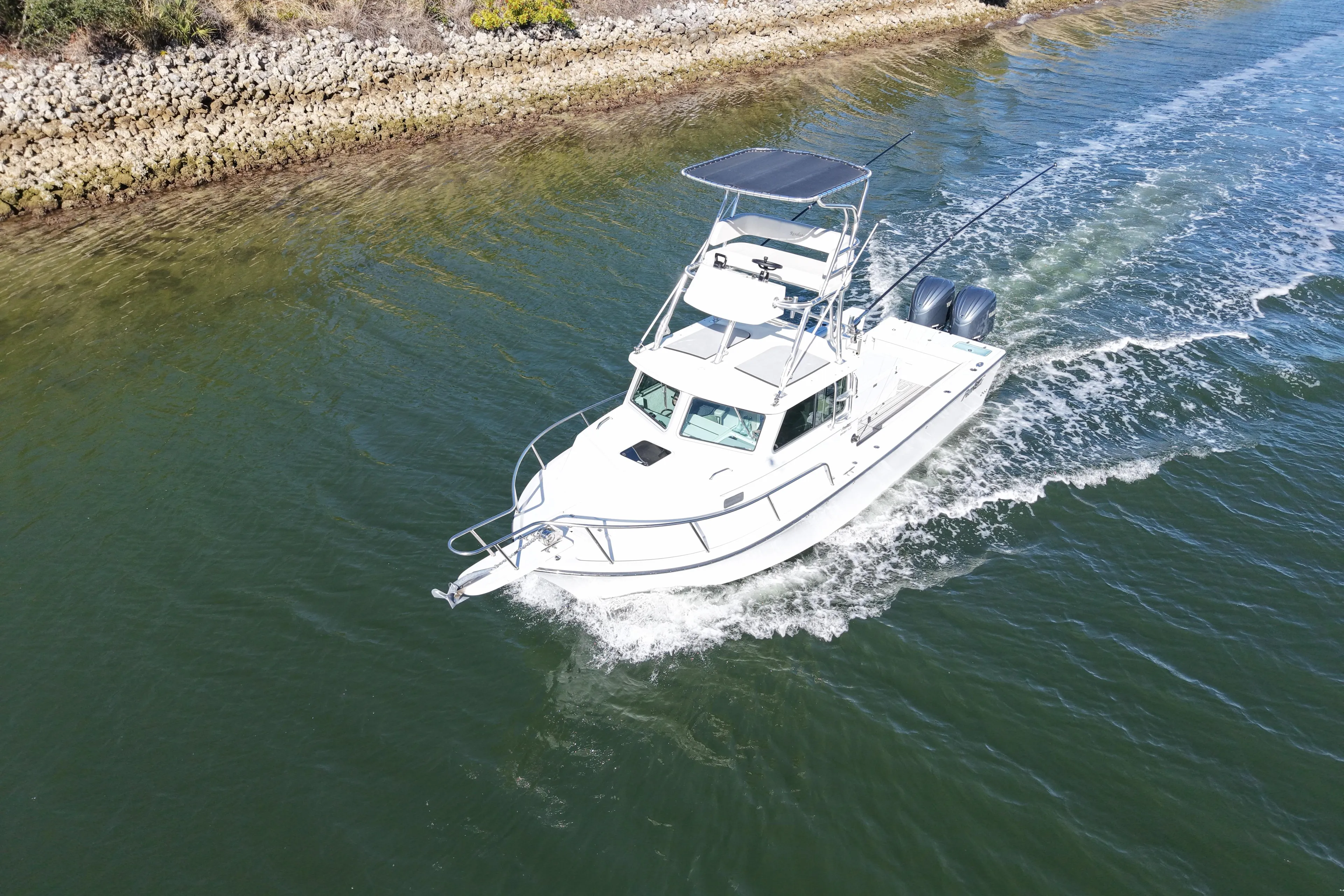 2023 Parker 2820 XLD Sport Cabin boat cruising on a calm waterway.