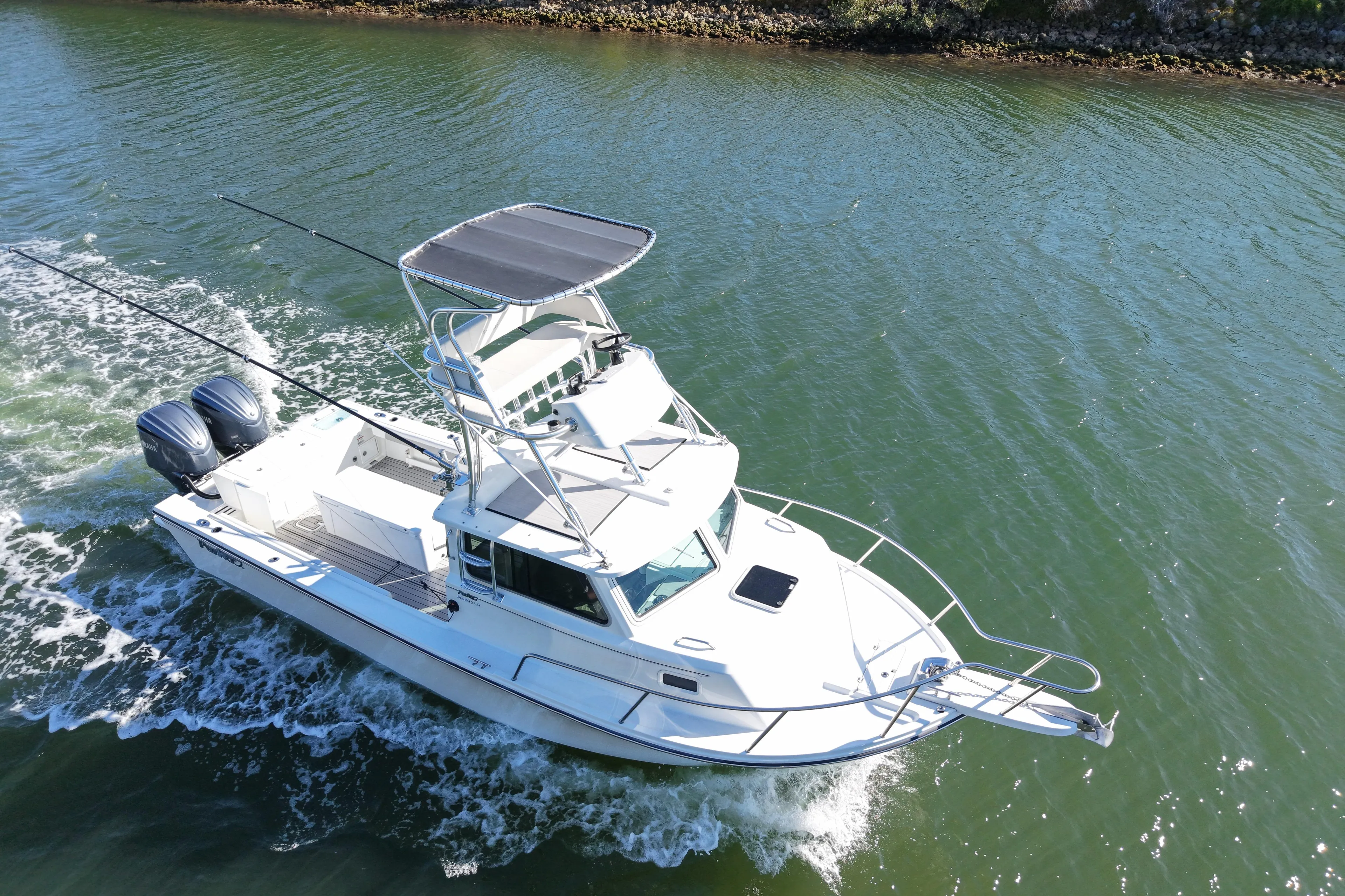 2023 Parker 2820 XLD Sport Cabin boat cruising on a calm waterway.