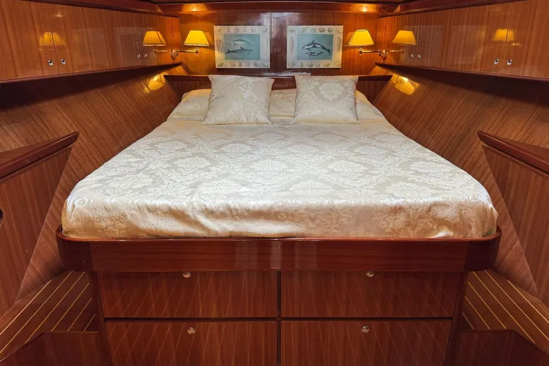  Yacht Photos Pics Luxurious cabin interior of 2003 Hampton ALASKA 17 yacht with elegant bedding and warm lighting.