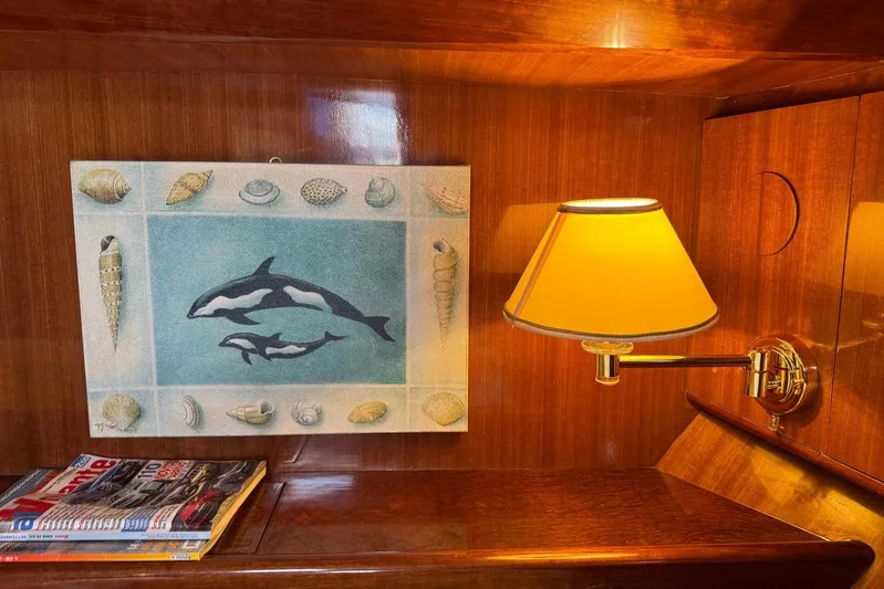  Yacht Photos Pics Wooden interior of 2003 Hampton ALASKA 17 with dolphin artwork and wall lamp.