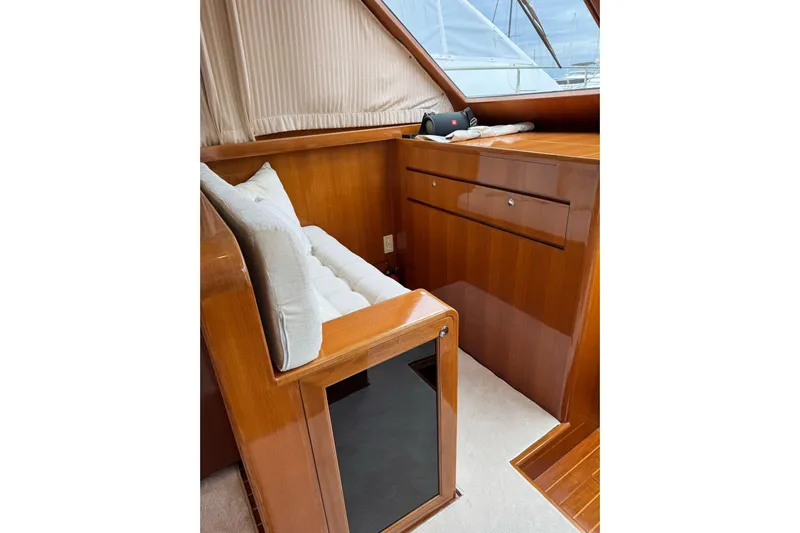  Yacht Photos Pics Interior of 2003 Hampton ALASKA 17 yacht with wooden cabinetry and cushioned seating.