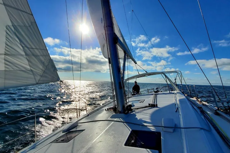  Yacht Photos Pics Sailing on a 2013 Beneteau Oceanis 45 yacht under a clear blue sky.