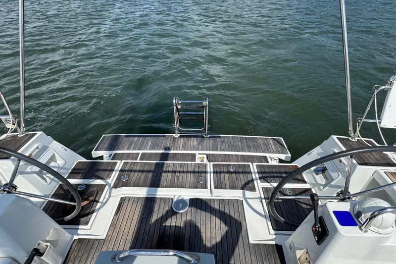  Yacht Photos Pics Beneteau Oceanis 45 yacht deck, 2013 model, featuring dual steering wheels and swim platform.