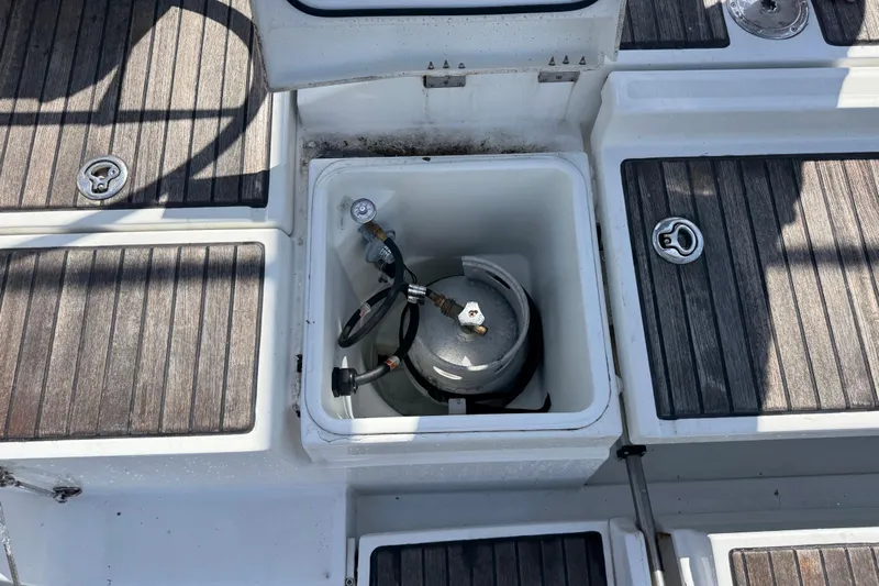  Yacht Photos Pics Beneteau Oceanis 45 (2013) deck with open storage compartment and propane tank.