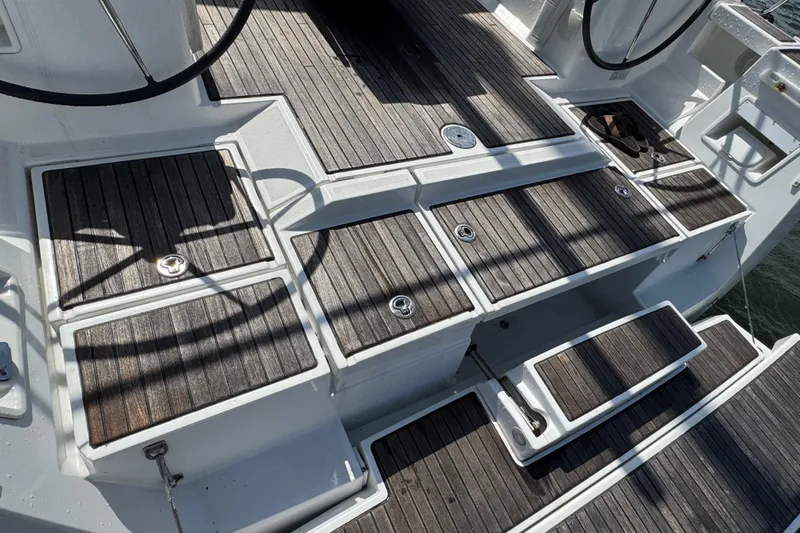  Yacht Photos Pics Teak deck of 2013 Beneteau Oceanis 45 sailboat, featuring storage compartments and steps.