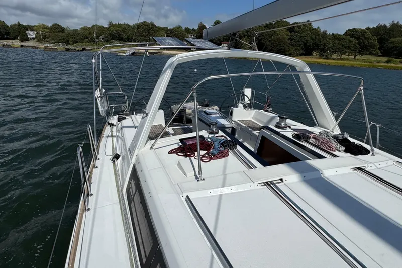  Yacht Photos Pics 2013 Beneteau Oceanis 45 sailboat on calm water, featuring a spacious deck and rigging.