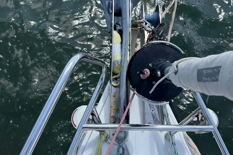  Yacht Photos Pics Beneteau Oceanis 45 sailboat deck view, showcasing rigging and water reflection.