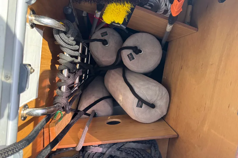  Yacht Photos Pics Storage compartment on a 2013 Beneteau Oceanis 45 with ropes and fenders.