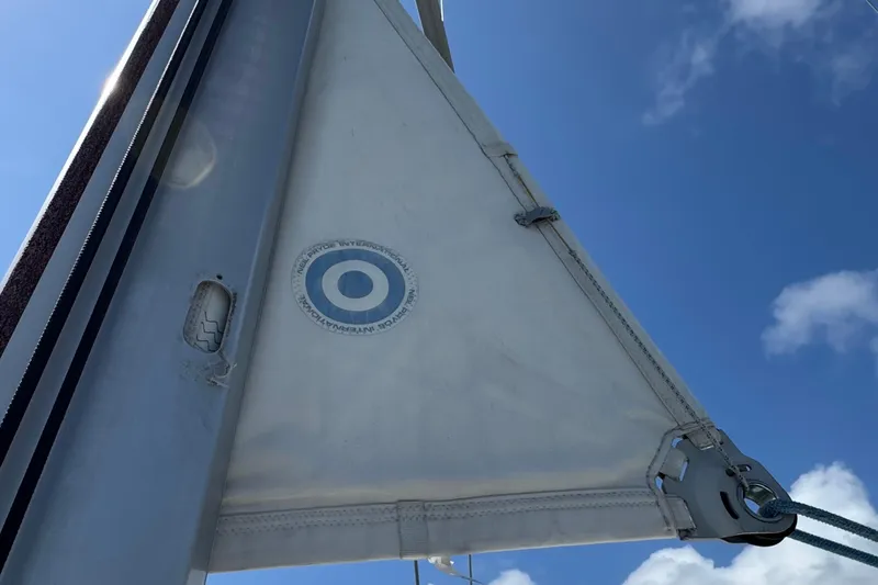  Yacht Photos Pics Sail of a 2013 Beneteau Oceanis 45 yacht against a clear blue sky.
