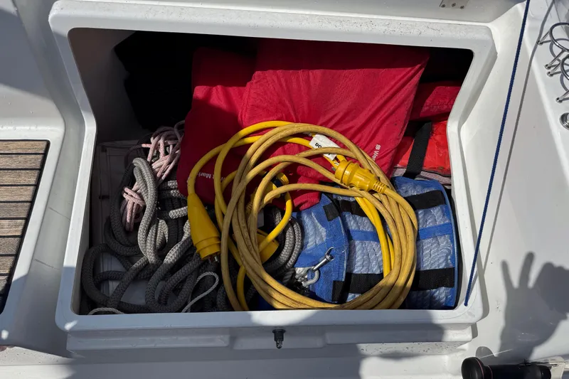  Yacht Photos Pics Storage compartment on a 2013 Beneteau Oceanis 45 with ropes, cables, and life jackets.