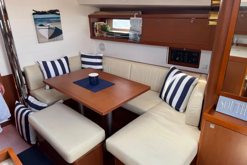  Yacht Photos Pics Interior of 2013 Beneteau Oceanis 45 yacht with cozy seating and nautical decor.