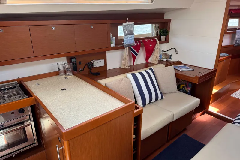  Yacht Photos Pics Interior of 2013 Beneteau Oceanis 45 yacht with cozy seating and modern kitchen.