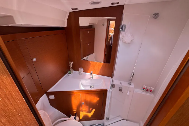  Yacht Photos Pics Luxurious bathroom interior of 2013 Beneteau Oceanis 45 yacht, featuring modern fixtures and wood accents.