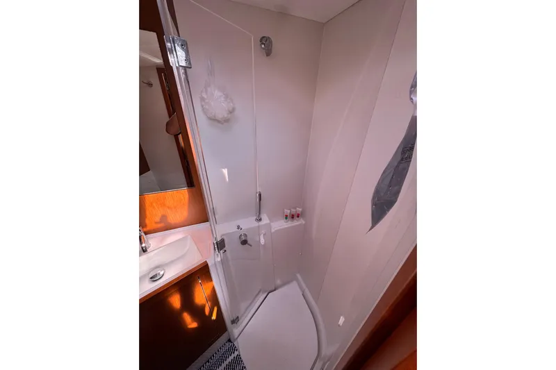  Yacht Photos Pics Bathroom interior of 2013 Beneteau Oceanis 45 yacht, featuring shower and sink.