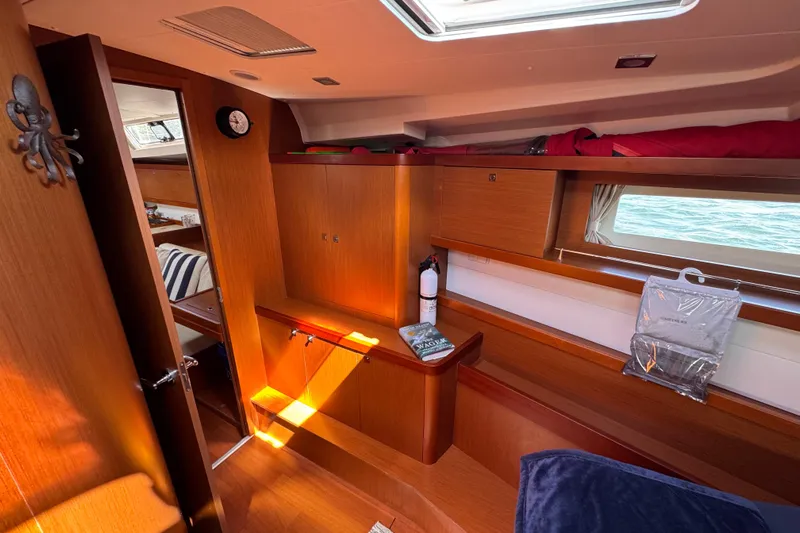 Yacht Photos Pics Interior of 2013 Beneteau Oceanis 45 yacht, featuring wooden cabinetry and nautical decor.