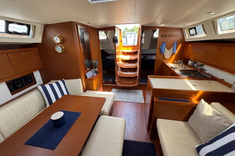  Yacht Photos Pics Luxurious interior of a 2013 Beneteau Oceanis 45 yacht with elegant wood finishes.