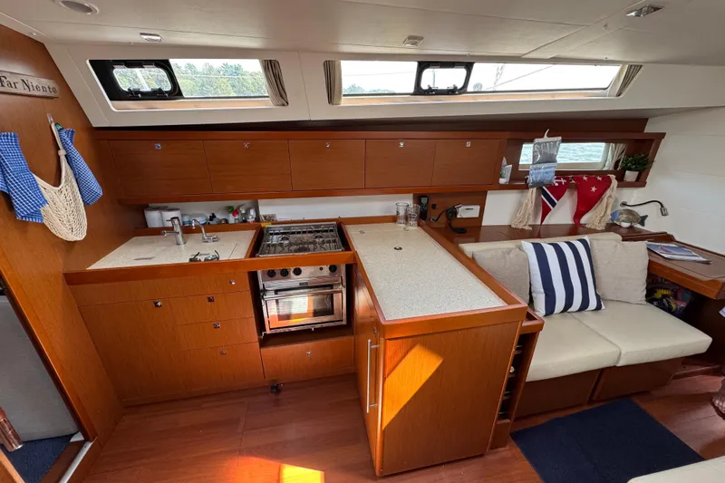  Yacht Photos Pics Interior of 2013 Beneteau Oceanis 45 yacht, featuring a modern kitchen and cozy seating area.