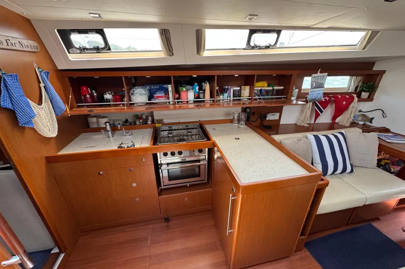  Yacht Photos Pics Interior of 2013 Beneteau Oceanis 45 yacht, featuring a well-equipped kitchen and cozy seating area.