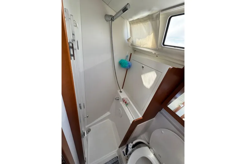  Yacht Photos Pics Bathroom interior of 2013 Beneteau Oceanis 45 yacht, featuring shower and toilet.