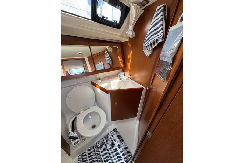  Yacht Photos Pics Bathroom interior of 2013 Beneteau Oceanis 45 yacht, featuring toilet and sink.