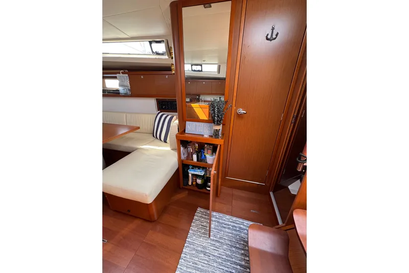  Yacht Photos Pics Interior of 2013 Beneteau Oceanis 45 yacht with cozy seating and wooden cabinetry.