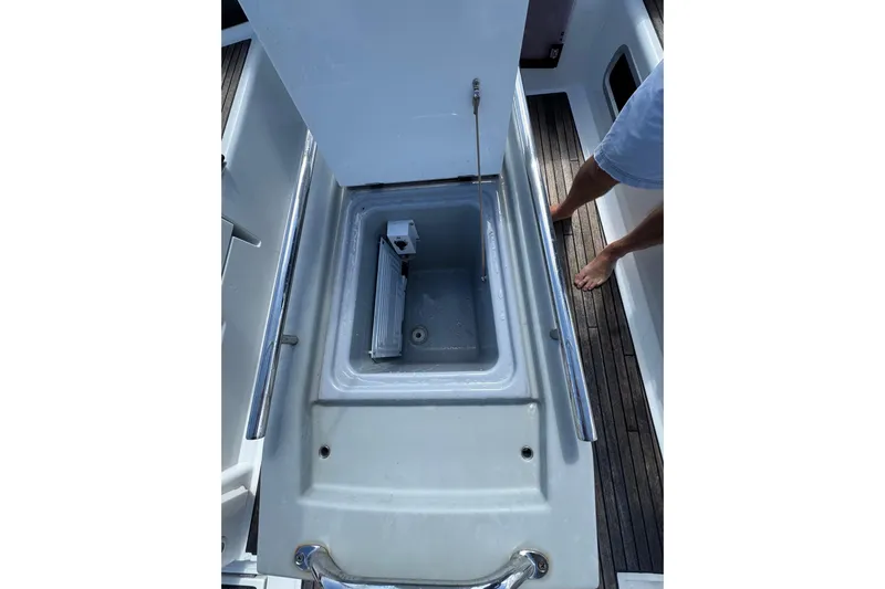  Yacht Photos Pics 2013 Beneteau Oceanis 45 yacht cockpit storage compartment with open lid and visible interior.