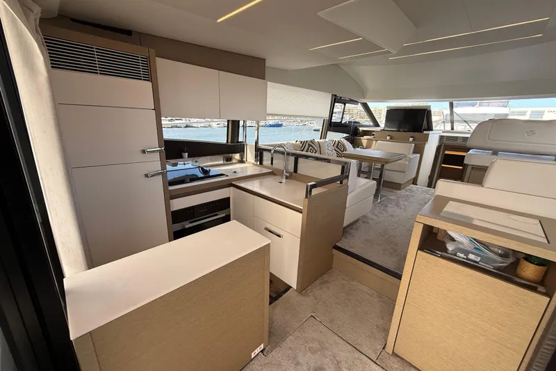 Yacht Photos Pics Luxurious interior of 2020 Prestige 520 yacht with modern kitchen and seating area.