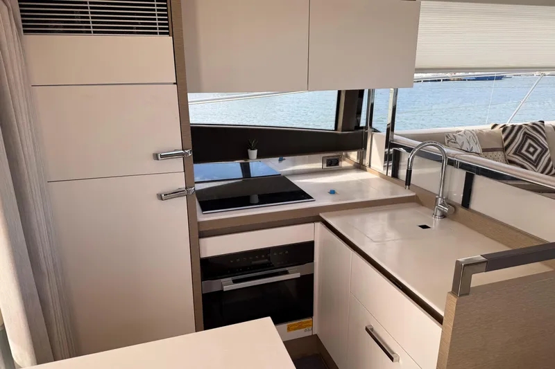  Yacht Photos Pics Modern kitchen interior on a 2020 Prestige 520 yacht with sleek design and ocean view.