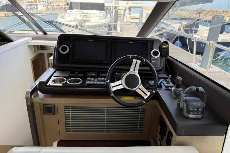  Yacht Photos Pics Cockpit of 2020 Prestige 520 yacht with modern navigation controls and steering wheel.