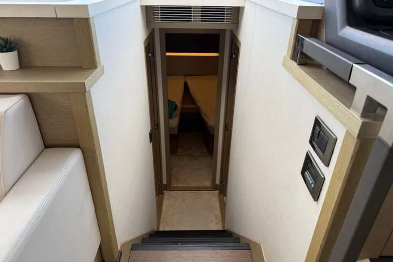  Yacht Photos Pics Interior view of 2020 Prestige 520 yacht, featuring stairs leading to a cozy cabin.