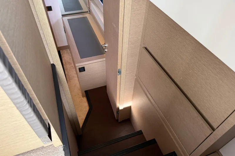  Yacht Photos Pics Interior stairs of 2020 Prestige 520 yacht, featuring modern design and wood finish.