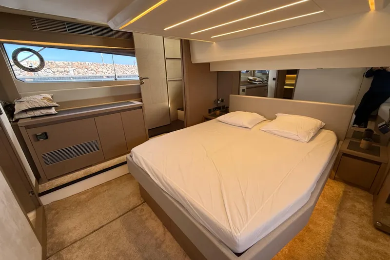  Yacht Photos Pics Luxurious bedroom interior of 2020 Prestige 520 yacht with modern design and cozy ambiance.