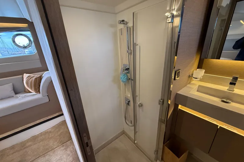  Yacht Photos Pics Luxurious bathroom interior of 2020 Prestige 520 yacht with modern shower and sink.