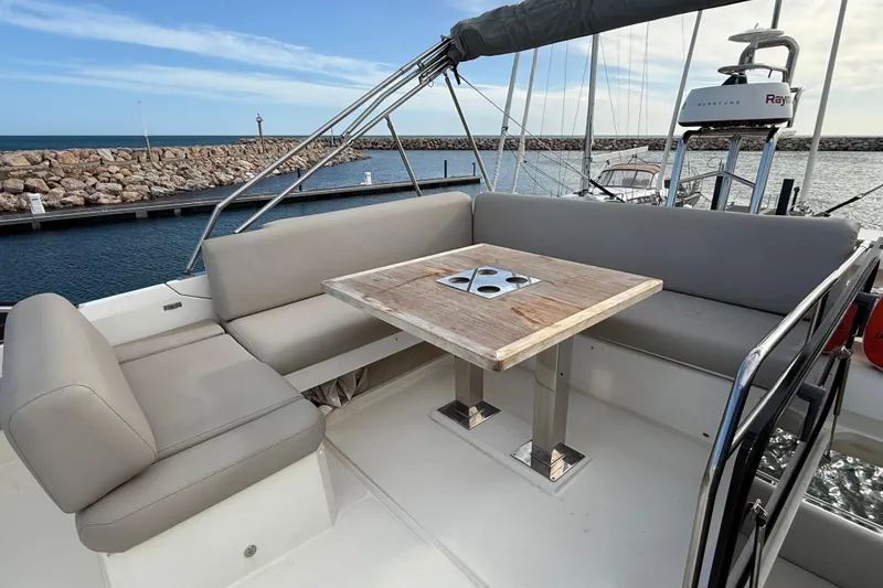 Yacht Photos Pics Luxurious 2020 Prestige 520 yacht deck with seating and table, docked by the sea.