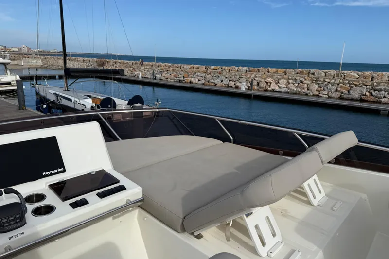  Yacht Photos Pics Prestige 520 yacht, 2020 model, docked with navigation equipment and sunbed, coastal view.