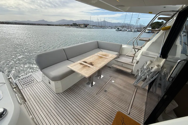  Yacht Photos Pics Prestige 520 yacht deck with seating and table, overlooking marina, 2020 model.
