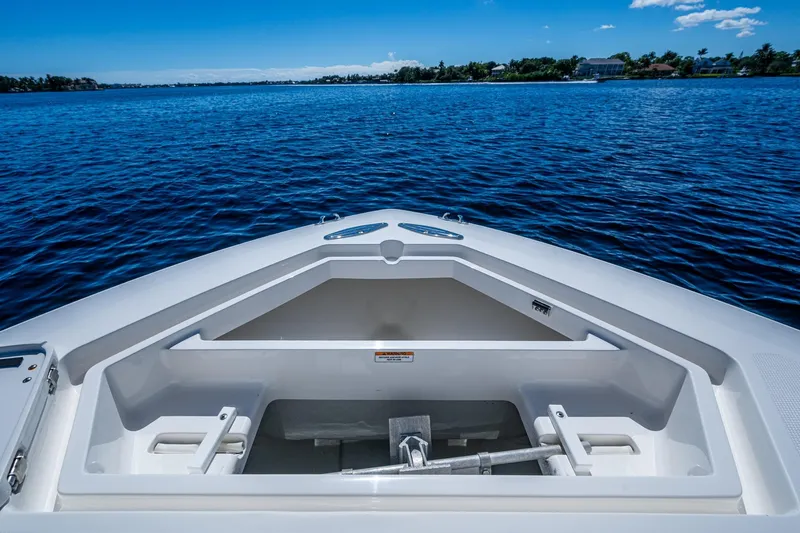 Da Bubbs Yacht Photos Pics 2024 SeaVee 322z boat bow with anchor storage, on calm blue water.