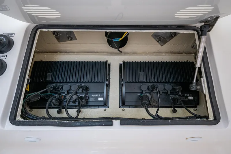 Da Bubbs Yacht Photos Pics 2024 SeaVee 322z boat electronics compartment with dual black control units.