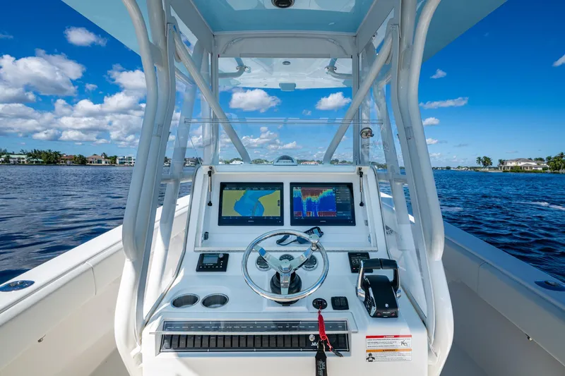 Da Bubbs Yacht Photos Pics 2024 SeaVee 322z boat dashboard with navigation screens on a sunny day.