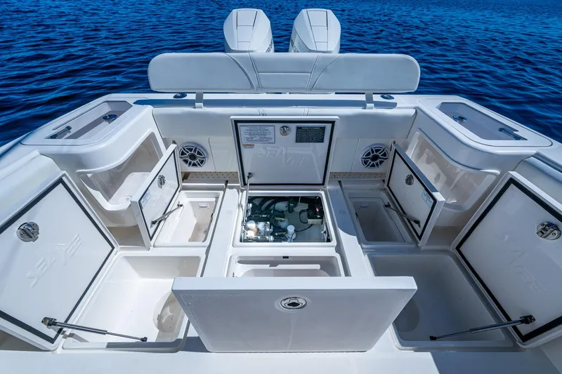 Da Bubbs Yacht Photos Pics 2024 SeaVee 322z boat interior with open storage compartments on blue water.