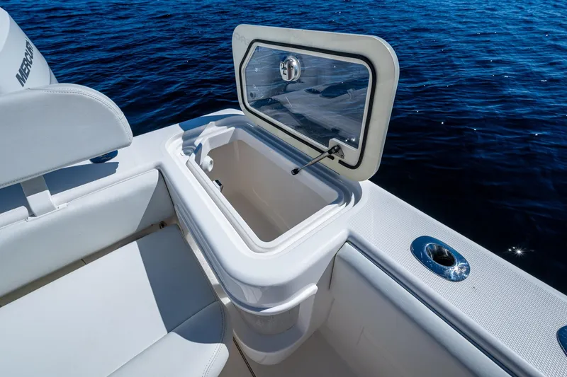 Da Bubbs Yacht Photos Pics 2024 SeaVee 322z boat with open storage compartment, white seating, and ocean backdrop.
