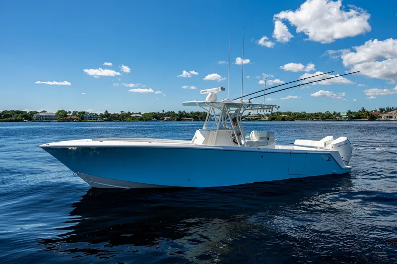 Da Bubbs Yacht Photos Pics 2024 SeaVee 322z boat on calm water under a clear blue sky.