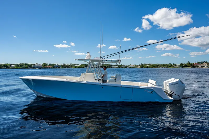 Da Bubbs Yacht Photos Pics 2024 SeaVee 322z boat on calm water under a clear blue sky.