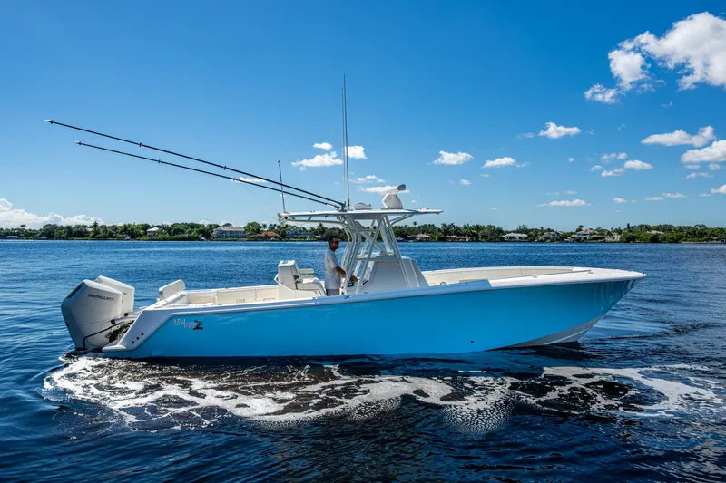 Da Bubbs Yacht Photos Pics 2024 SeaVee 322z boat on calm water under a clear blue sky.