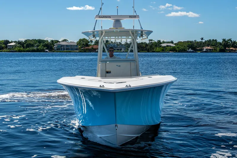 Da Bubbs Yacht Photos Pics 2024 SeaVee 322z boat on calm water, featuring a sleek blue hull design.